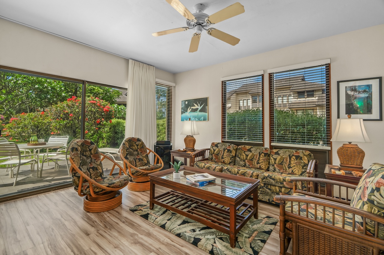 1901 Poipu Road, Unit 411 Koloa, HI 96756 - Photo 2 of 28 a living room with furniture large windows and wooden floor