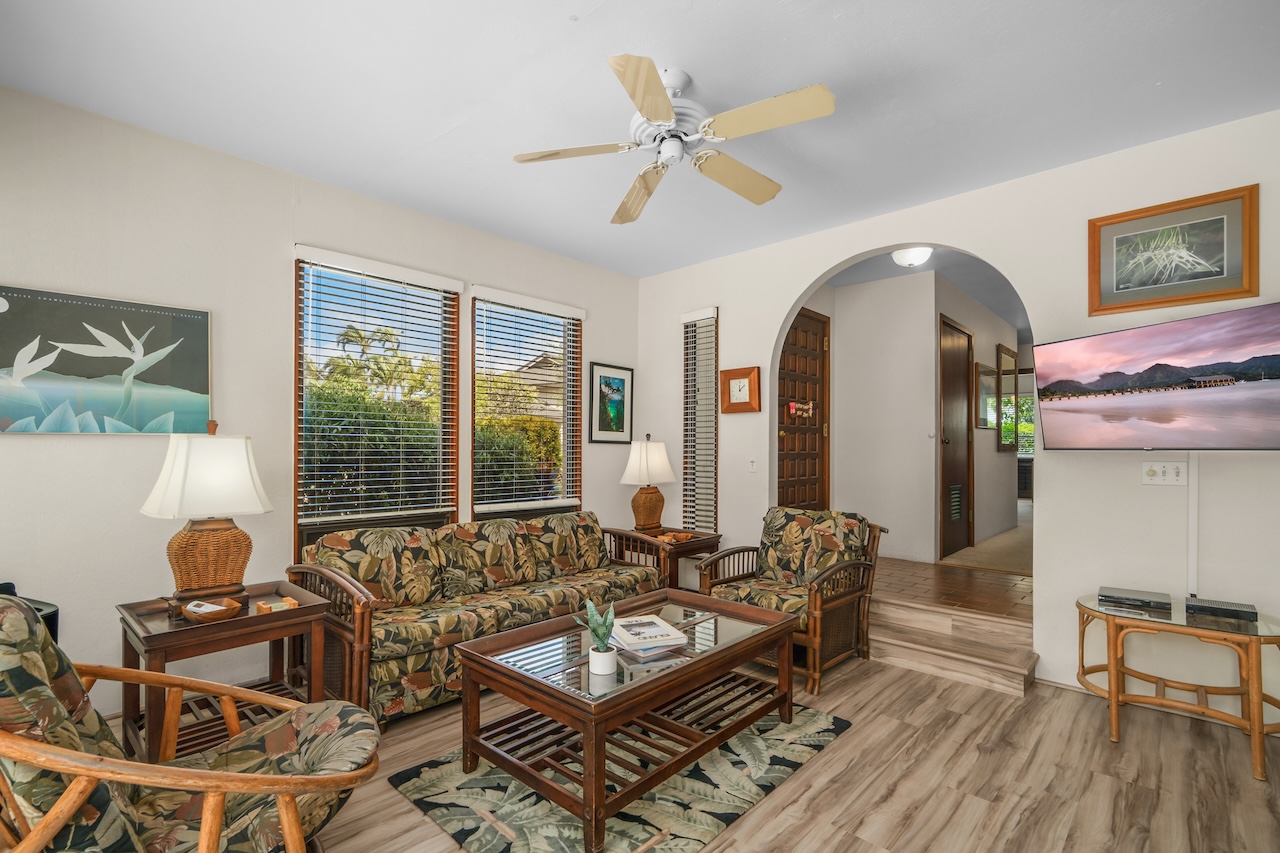 1901 Poipu Road, Unit 411 Koloa, HI 96756 - Photo 5 of 28 a living room with furniture a wooden floor and a window
