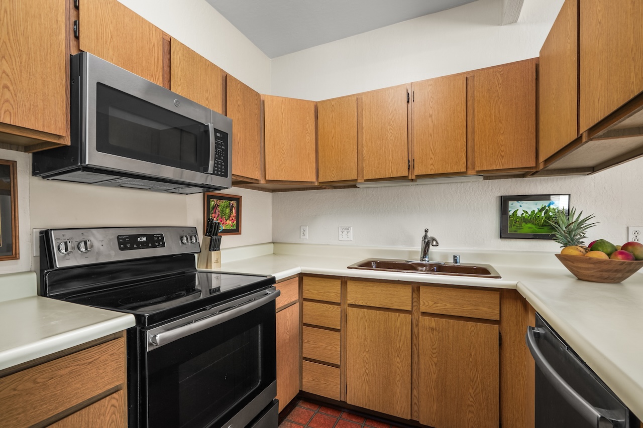 1901 Poipu Road, Unit 411 Koloa, HI 96756 - Photo 9 of 28 a kitchen with a sink stove and microwave