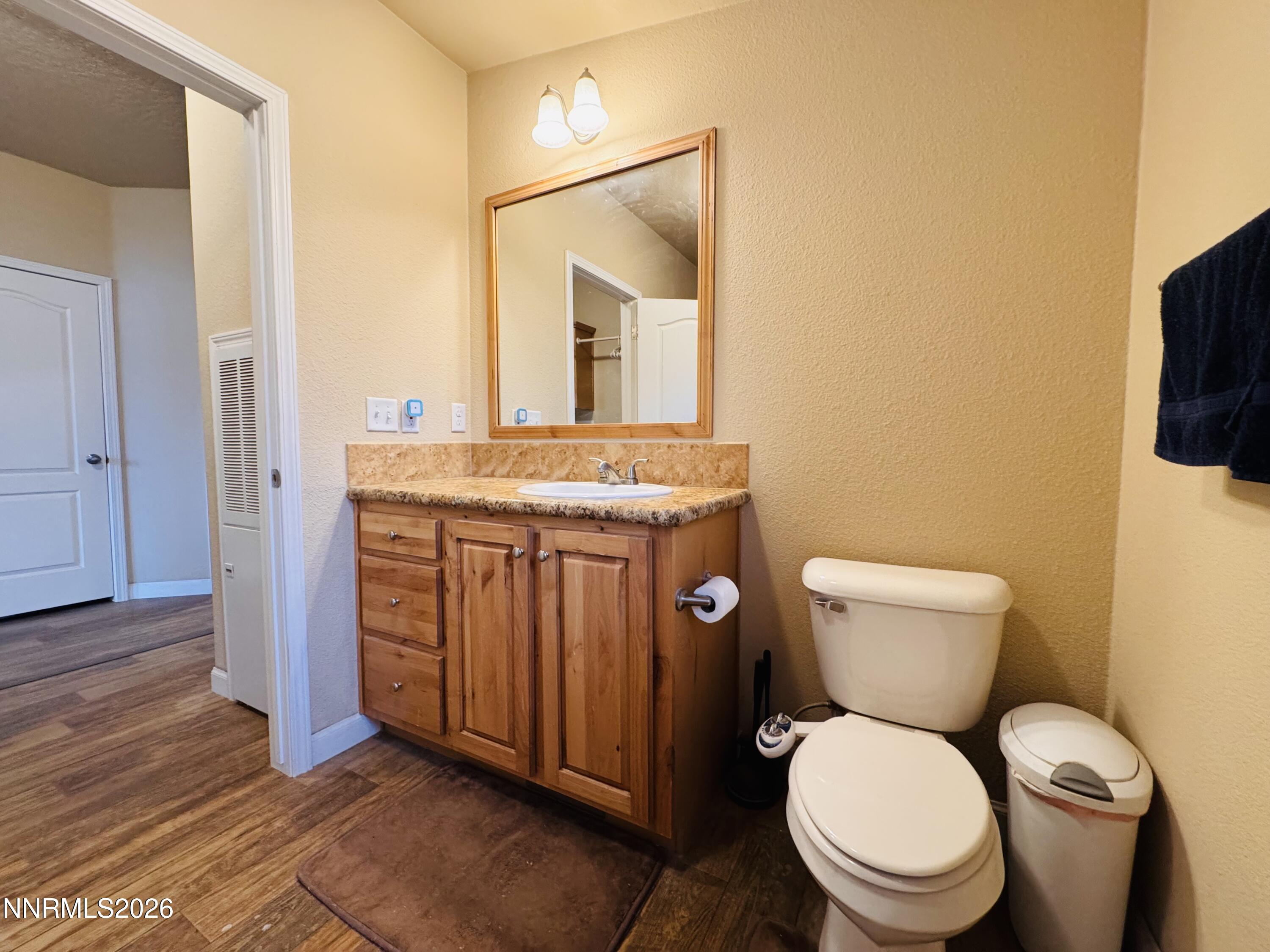 29400 Kings River Road Orovada, NV 89425 - Photo 21 of 40 a bathroom with a granite countertop toilet a mirror and a sink
