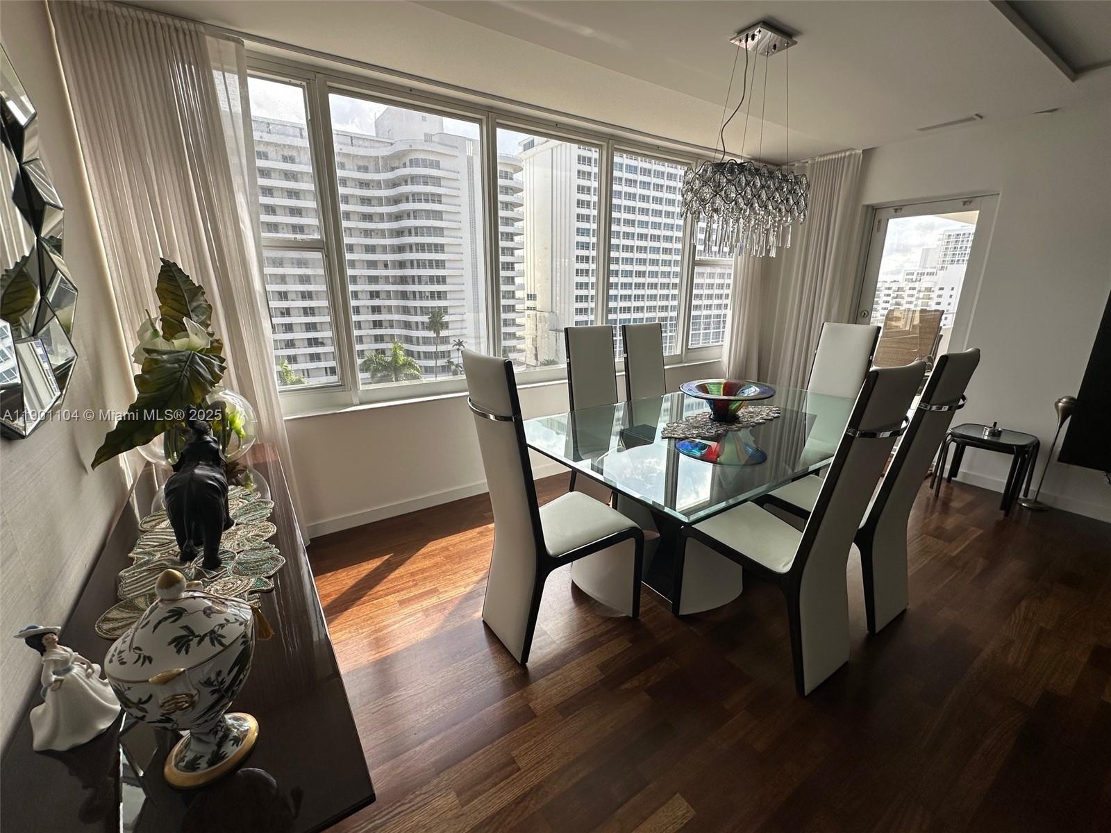 5600 Collins Avenue, Unit 9E Miami Beach, FL 33140 - Photo 13 of 55 a dining room with furniture window wooden floor