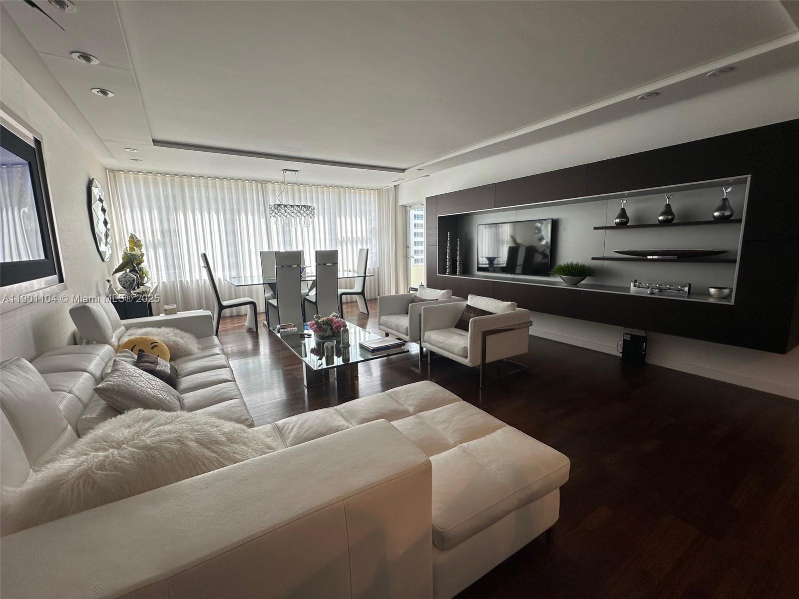 5600 Collins Avenue, Unit 9E Miami Beach, FL 33140 - Photo 17 of 55 a living room with furniture wooden floor and window