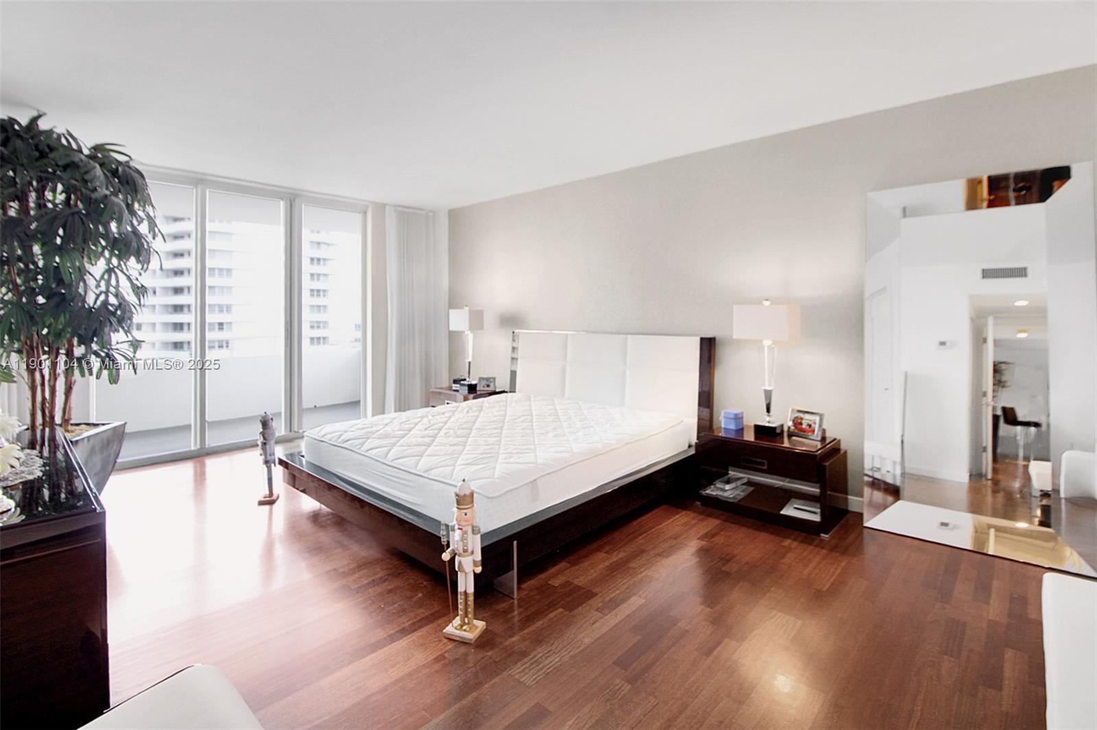 5600 Collins Avenue, Unit 9E Miami Beach, FL 33140 - Photo 18 of 55 a bed room with a bed and a potted plant