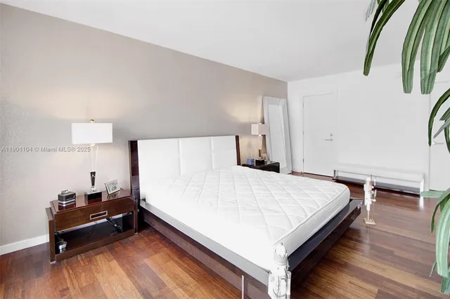 a bedroom with two beds and a large window