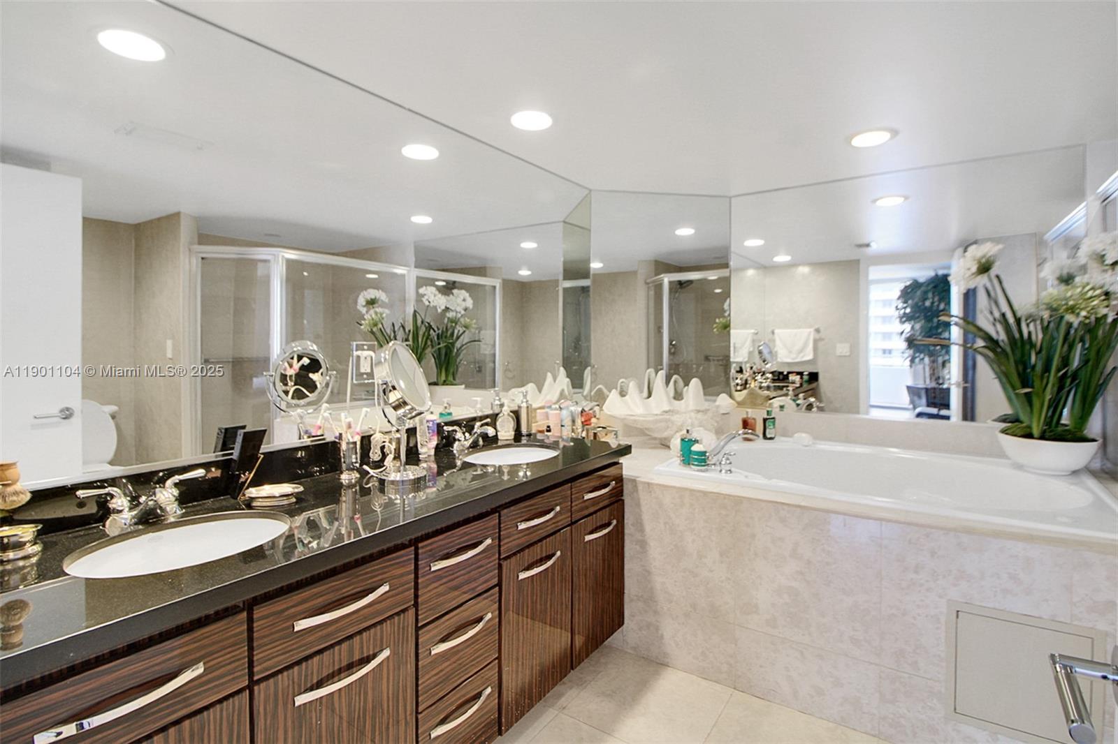 5600 Collins Avenue, Unit 9E Miami Beach, FL 33140 - Photo 22 of 55 a large kitchen with granite countertop a sink and a white cabinets