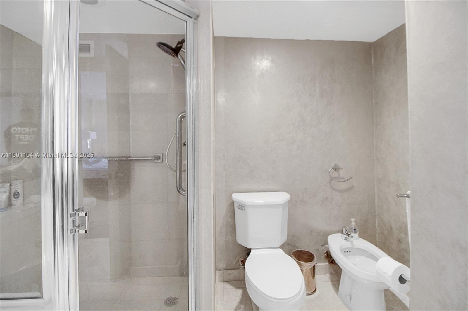 5600 Collins Avenue, Unit 9E Miami Beach, FL 33140 - Photo 24 of 55 a white toilet sitting next to a bathroom sink