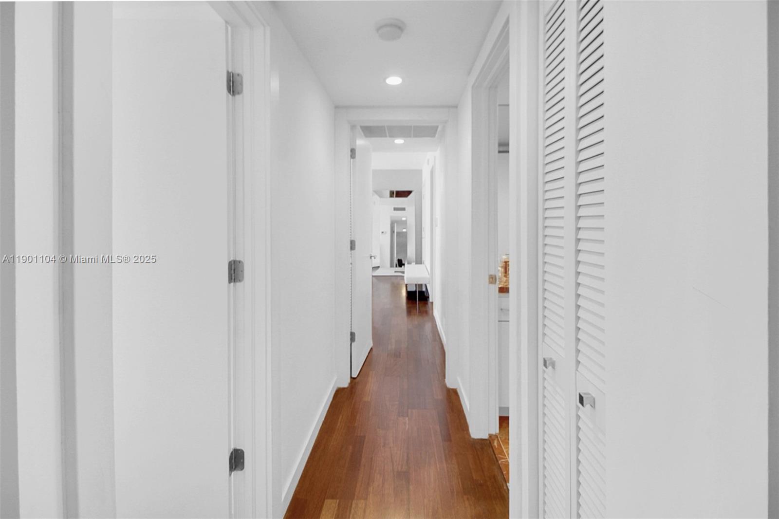 5600 Collins Avenue, Unit 9E Miami Beach, FL 33140 - Photo 25 of 55 a view of a hallway with wooden floor and closet area