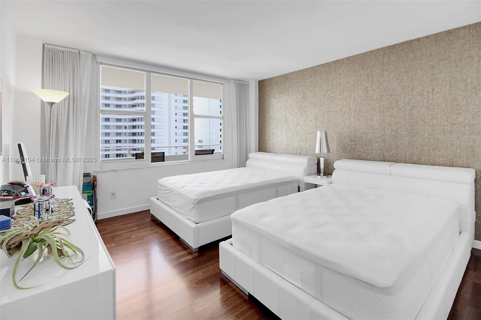 5600 Collins Avenue, Unit 9E Miami Beach, FL 33140 - Photo 26 of 55 a bedroom with two beds and a large window