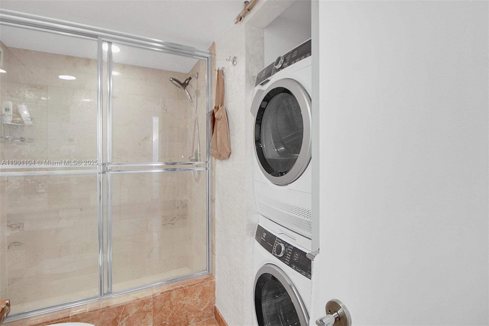 5600 Collins Avenue, Unit 9E Miami Beach, FL 33140 - Photo 30 of 55 a room with a washer and dryer