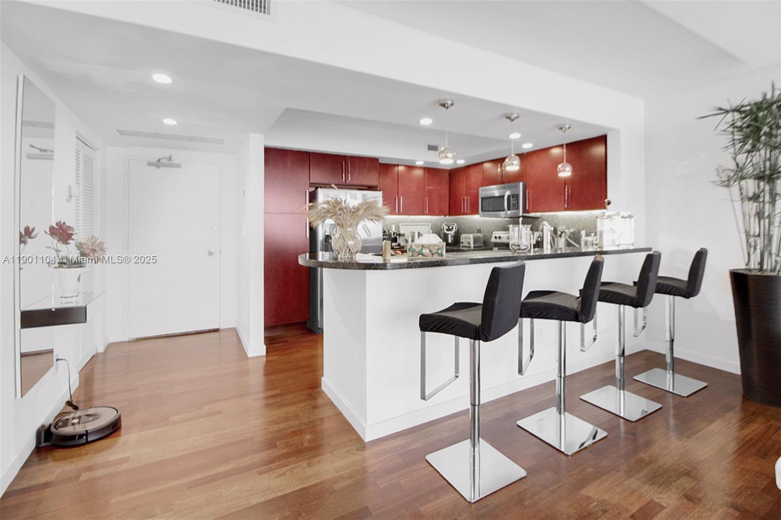 5600 Collins Avenue, Unit 9E Miami Beach, FL 33140 - Photo 10 of 55 a kitchen with granite countertop counter top space and cabinets