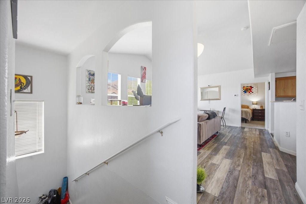 10550 West Alexander Road, Unit 2164 Las Vegas, NV 89129 - Photo 3 of 27 Archways and a light-filled living area provide a graceful transition from the stairwell into the home's main spaces.