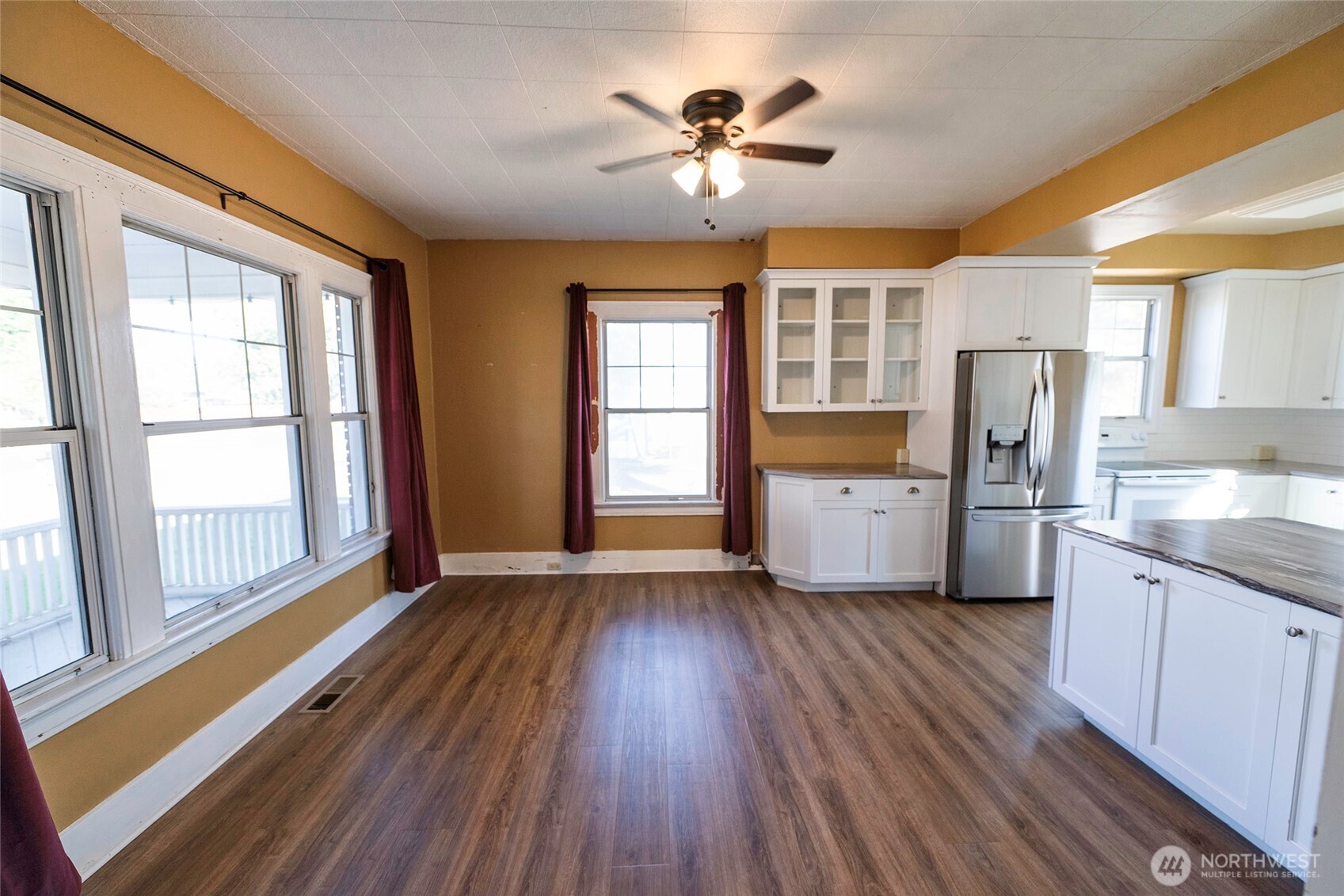 202 West 1st Street Prescott, WA 99348 - Photo 13 of 40 a view of an empty room with a kitchen and a window