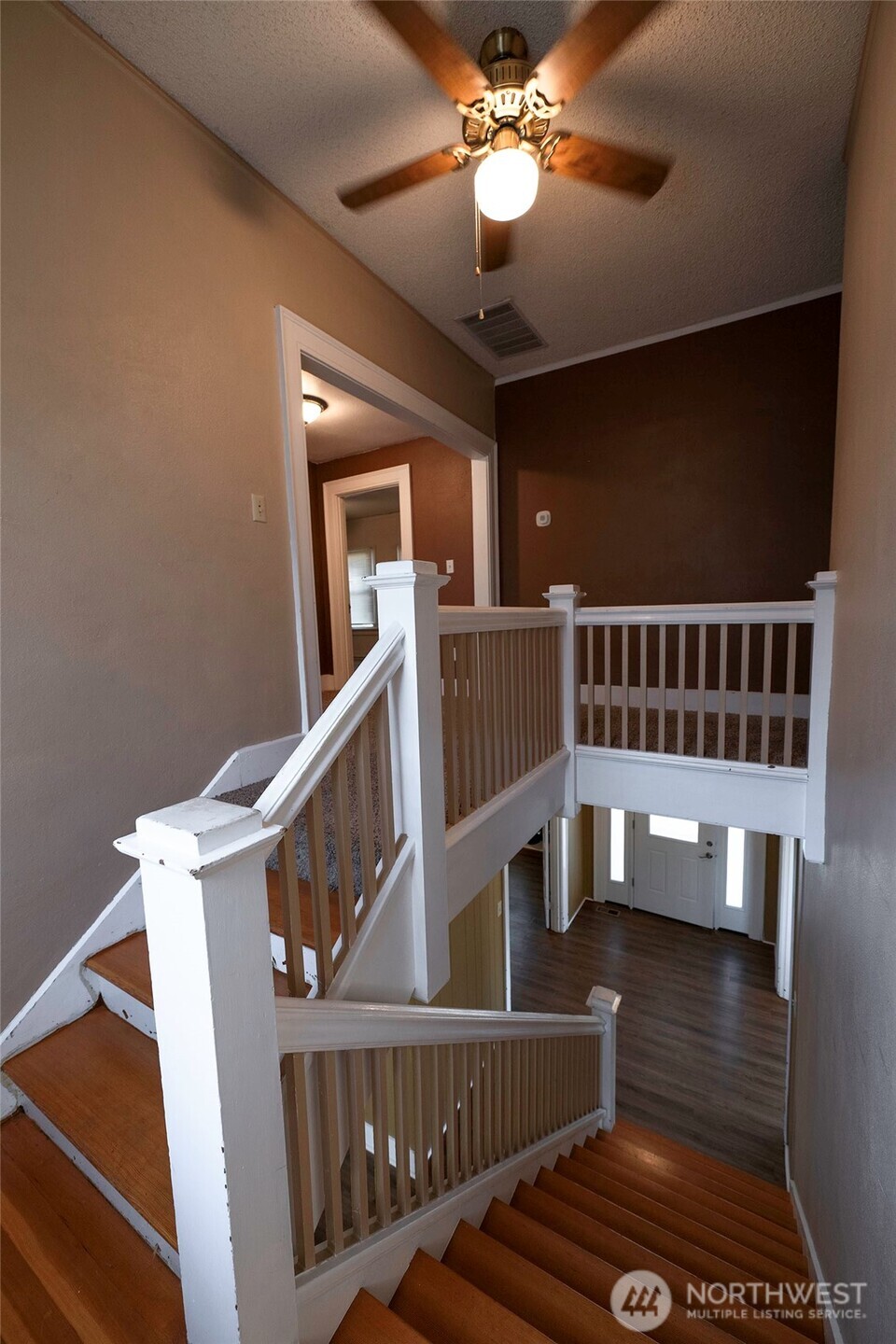 202 West 1st Street Prescott, WA 99348 - Photo 20 of 40 a view of staircase with railing and a chandelier