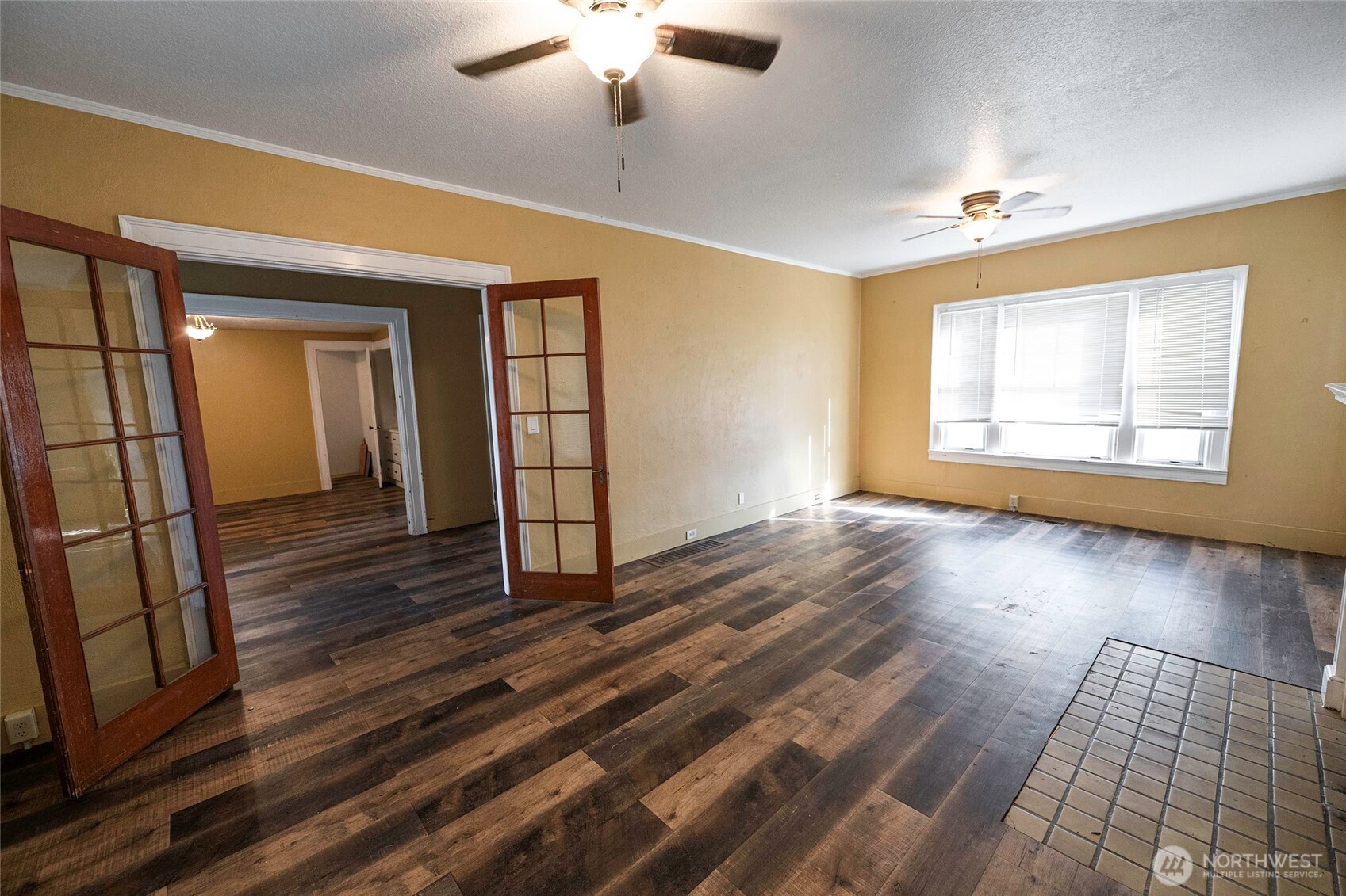 202 West 1st Street Prescott, WA 99348 - Photo 37 of 40 an empty room with wooden floor chandelier and windows
