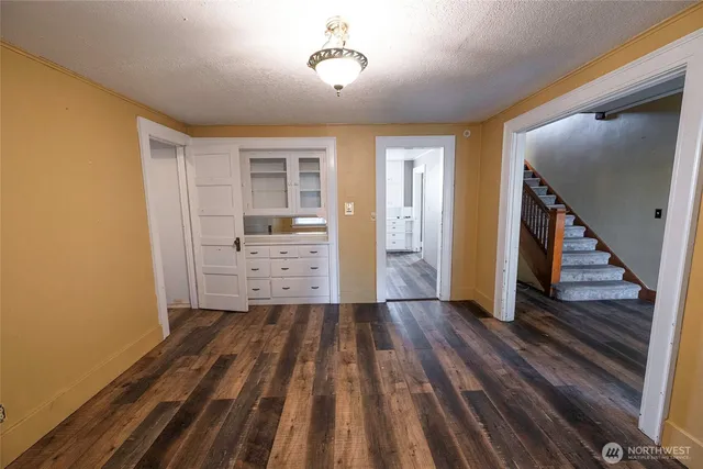 wooden floor in an empty room with a fireplace