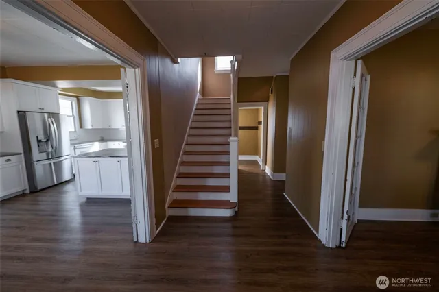 a view of entryway and hall with wooden floor