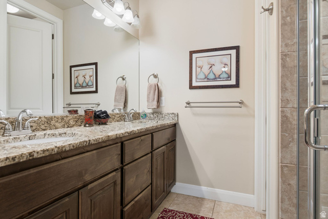 4269 Razor Drive Washington, UT 84780 - Photo 9 of 50 Full bath with double vanity, a stall shower, and light tile patterned flooring