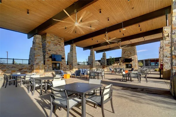 a view of a patio with table and chairs