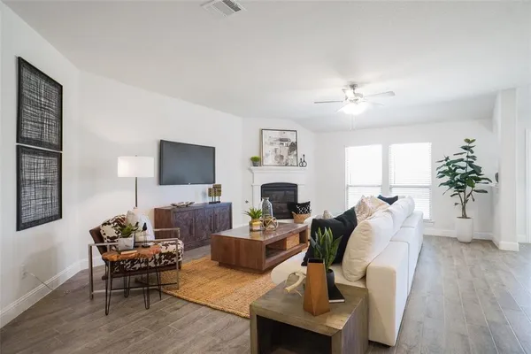 a living room with furniture fireplace and a flat screen tv