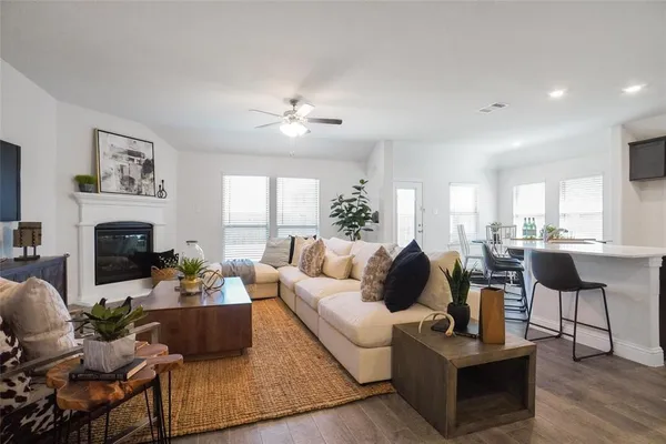 a living room with fireplace furniture and a fireplace