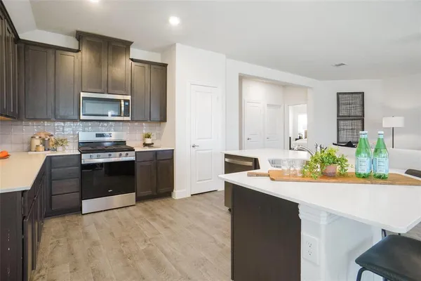a kitchen with granite countertop stainless steel appliances and sink