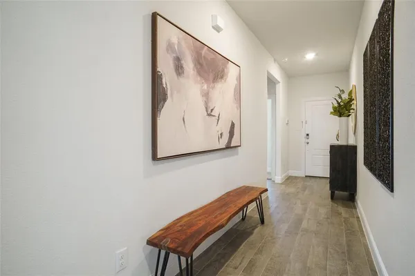 a view of a hallway with paintings on the wall