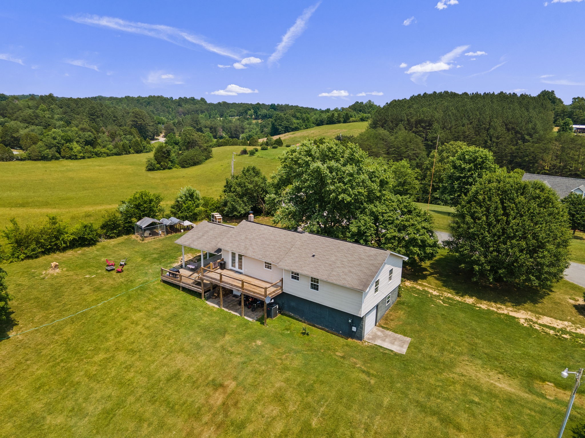 277 Harrison Road Spring City, TN 37381 - Photo 6 of 36 a view of a lake with lawn chairs and large trees