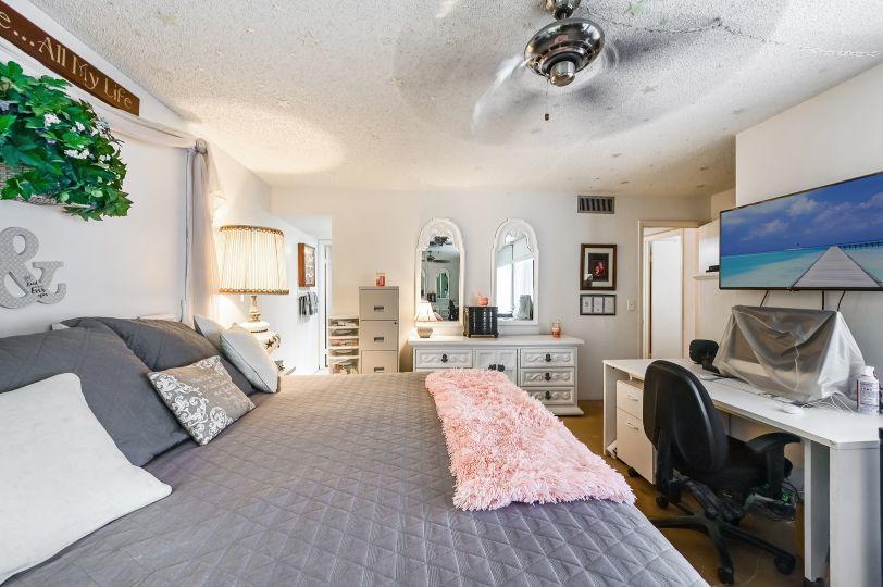 126 Woodland Road Palm Springs, FL 33461 - Photo 11 of 19 a bedroom with furniture and a fireplace