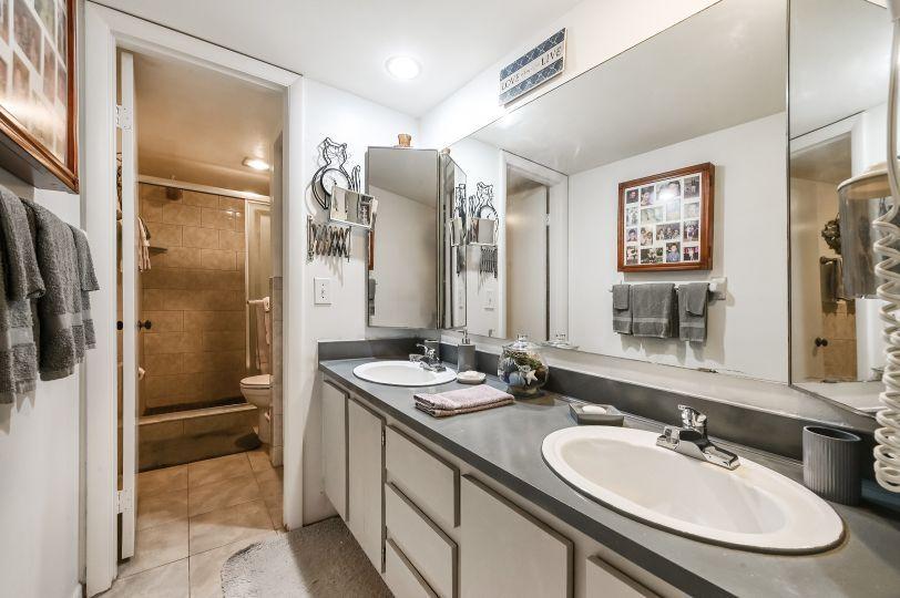 126 Woodland Road Palm Springs, FL 33461 - Photo 12 of 19 a bathroom with a sink double vanity and a shower