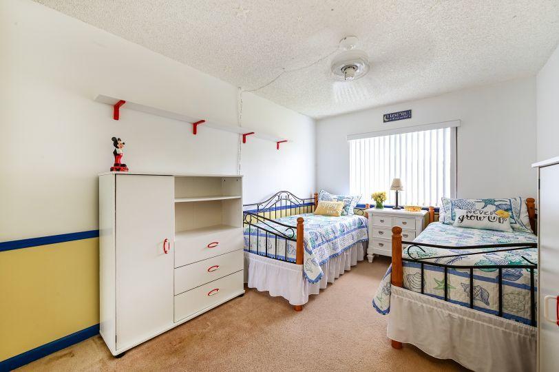 126 Woodland Road Palm Springs, FL 33461 - Photo 13 of 19 a bedroom with a bed and a table