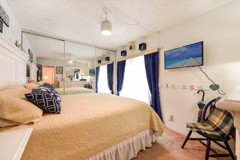 126 Woodland Road Palm Springs, FL 33461 - Photo 14 of 19 a bedroom with a bed and a chair