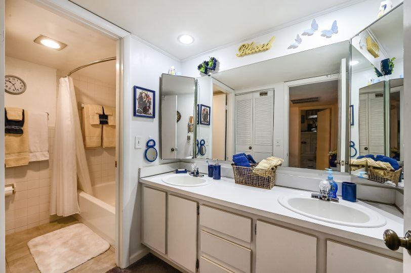 126 Woodland Road Palm Springs, FL 33461 - Photo 15 of 19 a bathroom with double vanity sink a mirror and a shower