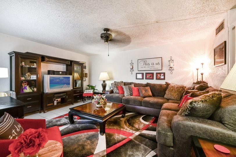 126 Woodland Road Palm Springs, FL 33461 - Photo 2 of 19 a living room with furniture and a flat screen tv