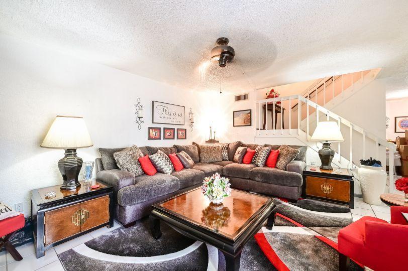 126 Woodland Road Palm Springs, FL 33461 - Photo 3 of 19 a living room with furniture and a lamp