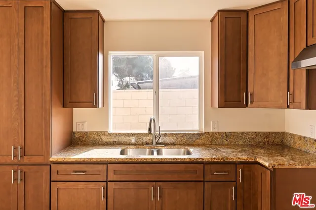 a kitchen with stainless steel appliances granite countertop a sink and a cabinets