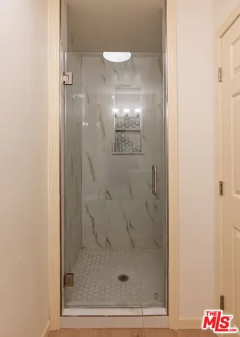 a bathroom with a glass shower door