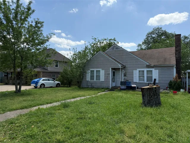 a front view of house with yard and outdoor seating