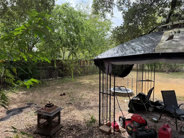 a view of a wooden deck and a backyard