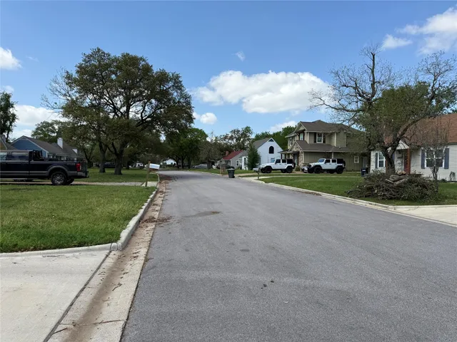 a view of a street with a building and a street sign