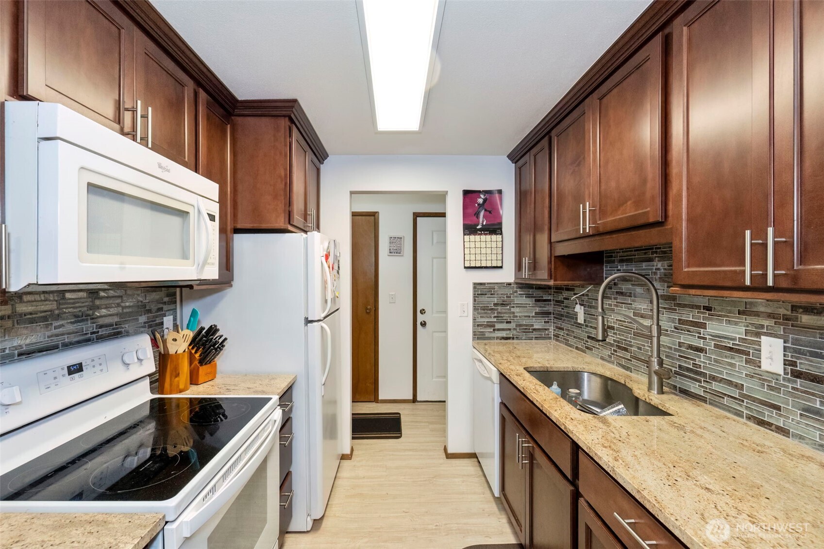 3400 Narrows View Lane Northeast, Unit 204 Bremerton, WA 98310 - Photo 17 of 38 a kitchen with stainless steel appliances granite countertop a sink stove and refrigerator