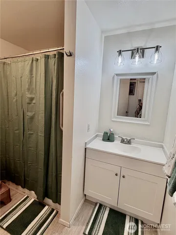 a bathroom with a sink a mirror a vanity and a toilet