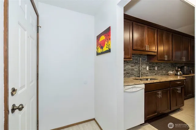 a kitchen with granite countertop stainless steel appliances and wooden cabinets