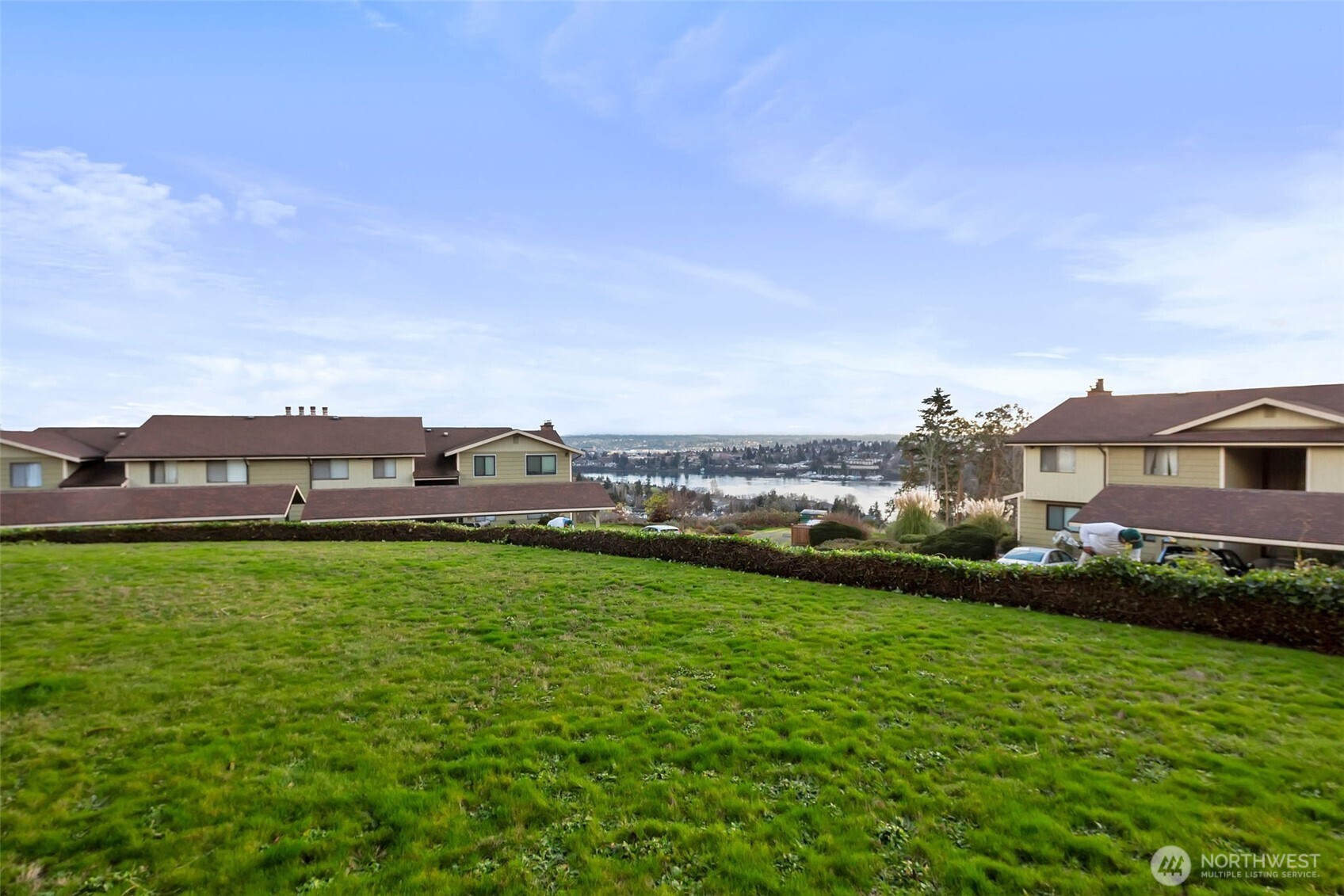 3400 Narrows View Lane Northeast, Unit 204 Bremerton, WA 98310 - Photo 37 of 38 a view of a big house with a big yard and large trees