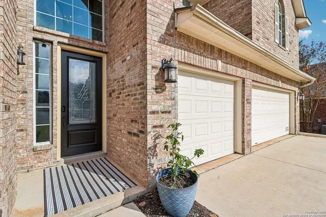 a view of a house with a yard and large trees