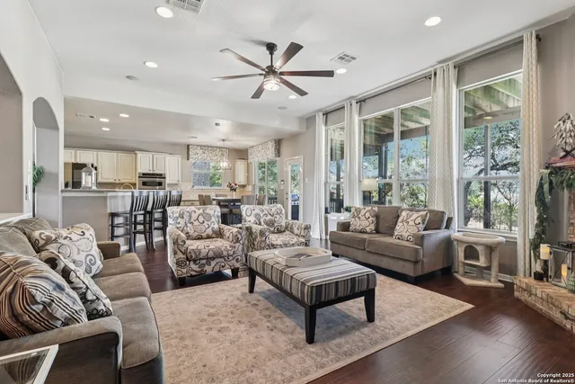 a living room with furniture and a chandelier