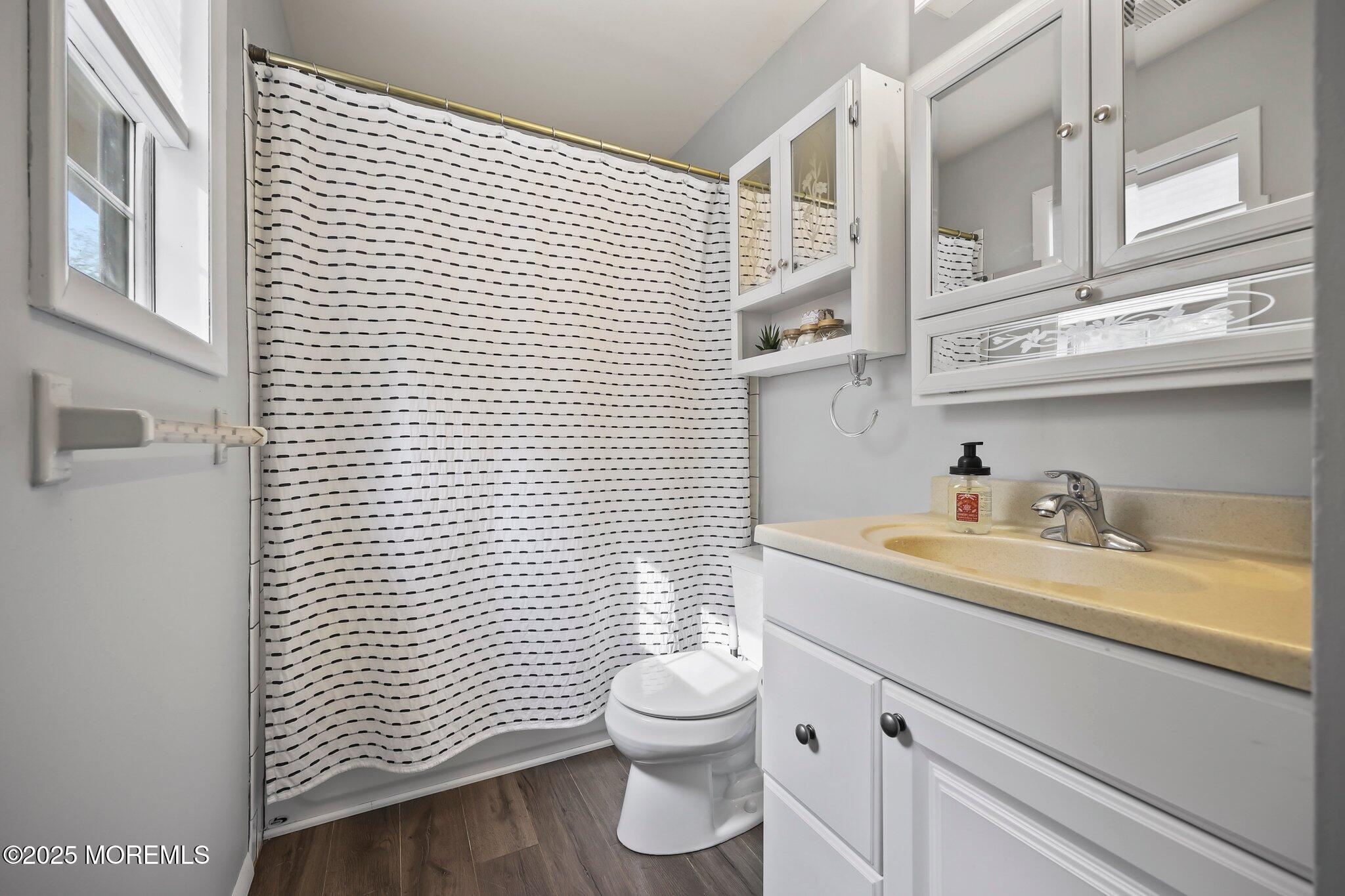 342 Diamond Road Jackson, NJ 08527 - Photo 12 of 30 a bathroom with a granite countertop sink toilet a mirror and shower curtain