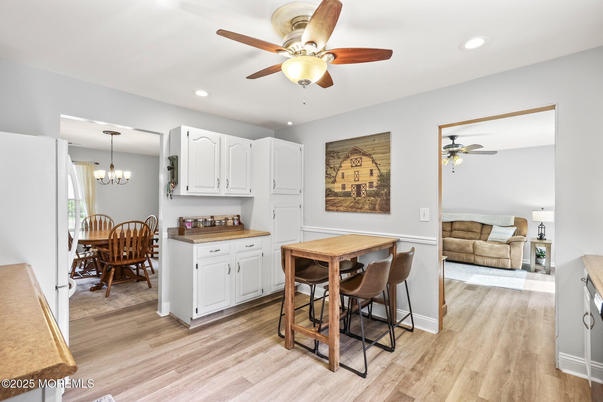342 Diamond Road Jackson, NJ 08527 - Photo 20 of 30 a kitchen with a dining table chairs and white appliances