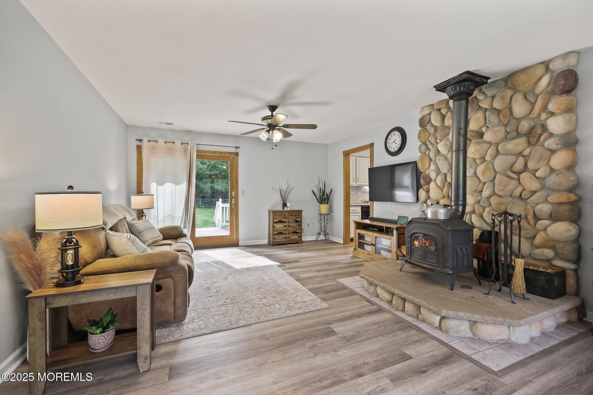 342 Diamond Road Jackson, NJ 08527 - Photo 5 of 30 a living room with furniture a flat screen tv and a fireplace