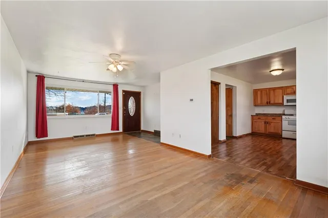 wooden floor in an empty room with a window