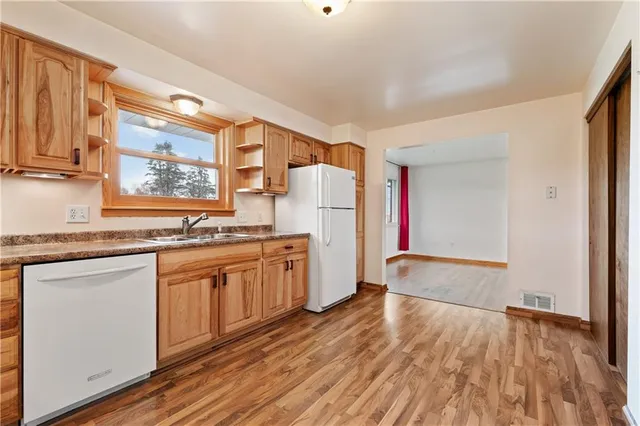 a kitchen with granite countertop a refrigerator and a sink